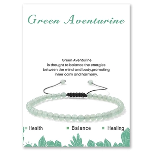 Close-up of Green Aventurine beaded bracelet on a descriptive display card with black cord