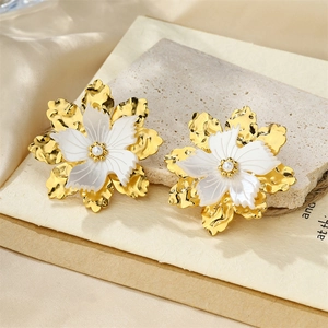 Golden textured metal flower stud earrings with white inner petals and center pearl accent