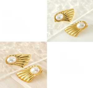 Detailed macro of fan-shaped gold pearl earrings with polished premium plating finish
