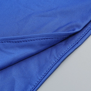 Macro shot of double-needle stitching on blue knit fabric for slim fit dress