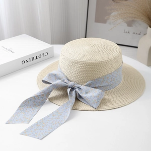 Beige straw boater hat with floral ribbon bow for summer beach sun protection
