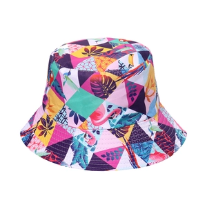 Women's reversible sun bucket hat featuring vibrant tropical bird and palm leaf prints