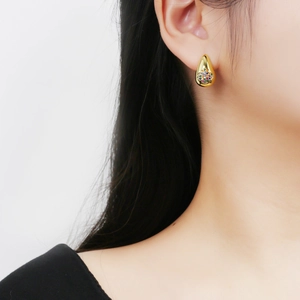 Elegant gold drop earrings with colorful zircon inlay shown on a female model