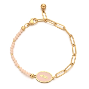 Detail of pink enamel feather charm on gold bead bracelet with stainless steel chain
