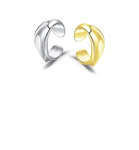 Detail of 925 sterling silver liquid metal ear cuffs with polished finish in gold and silver