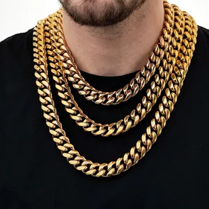 Set of four gold-colored chunky stainless steel Cuban link chains in layered style for men
