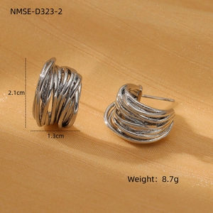 Macro shot of twisted silver stainless steel earrings with dimensions 2.1cm by 1.3cm