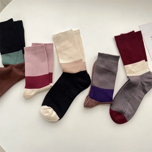 Close-up of five pairs of warm cashmere socks with retro color-block and ribbed texture