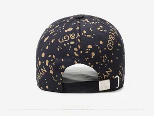 Detail of adjustable metal buckle and gold splattered texture on navy baseball cap