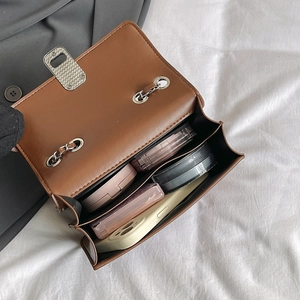 Brown faux leather chain crossbody bag for women showing spacious interior with essentials