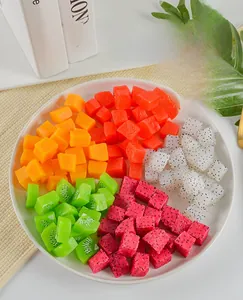 Macro detail of assorted artificial fruit cubes with realistic seeds and pulp textures