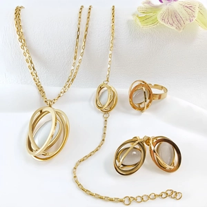 Detail shot of golden multi-loop jewelry set featuring translucent cat-eye stones