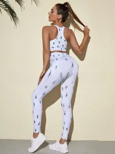 Detail of white yoga set featuring small black floral prints and moisture-wicking fabric