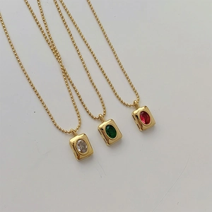 Detailed macro view of vintage square titanium steel pendants with inset colorful gemstones