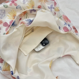 Detail view of the floral tote bag showing its inner zippered pocket and spacious interior