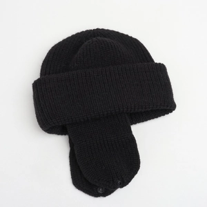 Detailed view of black knitted winter earflap hat with warm lining and chin snap button