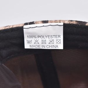 Detail of the leopard print baseball cap interior featuring the 100% polyester care label