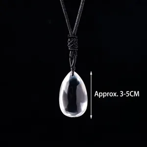 Detailed view of teardrop crystal pendant with black cord, measuring approx. 3-5cm