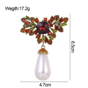 Vintage French floral brooch with red ruby, colored diamonds, and a large drop pearl