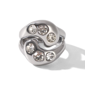 Macro shot of silver stainless steel ring with elegant wavy design and six inlaid zircons
