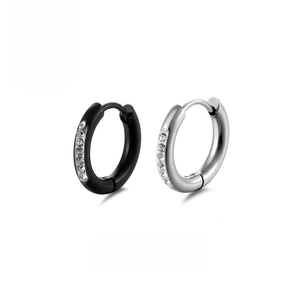 Detailed view of black and silver stainless steel navel rings with cubic zirconia inlay