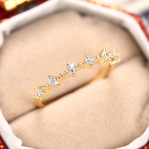 Detalle macro de un anillo fino de oro con circonitas brillantes engastadas en garras
