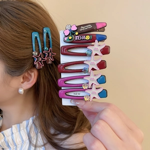 Detailed view of acrylic star and lipstick hair clips set on a display card