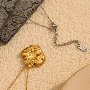 Detail view of 18K gold plated flower pendant with silver chain and K18 hallmark tag