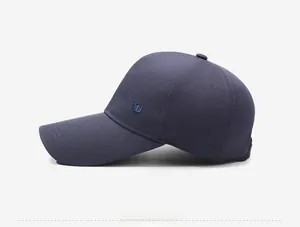 Detail view of navy blue baseball cap showing precise side embroidery and fabric texture