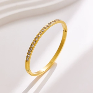 Elegant gold titanium steel bangle with sparkling cubic zirconia row and side hinge