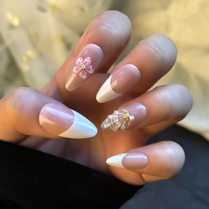 French almond press-on nails with 3D floral accents and seashell textures with pearls
