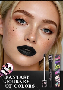 Detailed view of matte black lip gloss with skull design packaging and on-lip effect