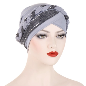 Detailed view of grey turban hat featuring black braided trim and silver sequins