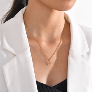 Fashion gold stainless steel necklace with heart-accented letter A pendant on model