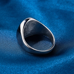 Macro detail of silver stainless steel ring showing polished surface and brushed interior texture