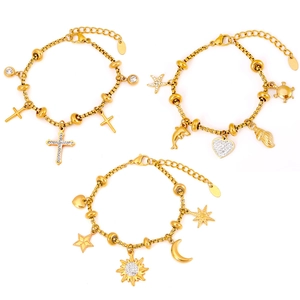 Three 18k gold plated titanium steel charm bracelets with cross, sea life, and celestial motifs