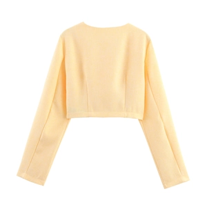 Vista posteriore piatta di una giacca corta in tweed giallo chiaro con trama fine e pulita