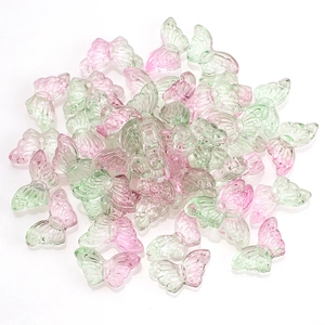 Close-up of 15mm butterfly crystal glass beads with pink and green gradient colors