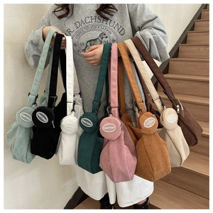 Collection of corduroy tote bags in multiple colors with wide straps and round pouches