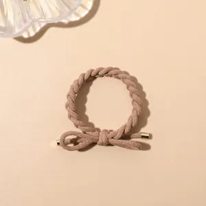 Detail of khaki braided hair tie with a bow knot and elegant gold metal end caps