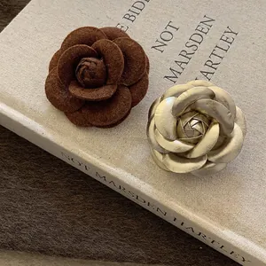 Handmade leather camellia flower brooch set with textured brown and champagne gold petals