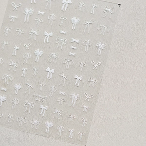 Macro view of white 3D embossed hand-drawn ribbon bow nail art stickers model TA-372
