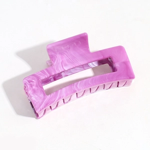 Close-up of purple marble texture on square resin hair claw clip with cutout design