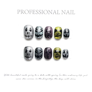 Detail of handmade Halloween cat eye press-on nails with glitter ghosts and pumpkins