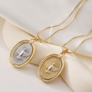 Vintage 18K gold plated eagle oval pendant necklaces with zircon on beige silk background