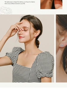 Detailed view of 925 silver infinity earrings set with clear stones on a female model