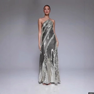 Elegant silver sequin halter neck evening gown with tassel hem and sleeveless slim fit