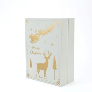 Detail of white book-style advent calendar with gold foil reindeer and Merry Christmas text