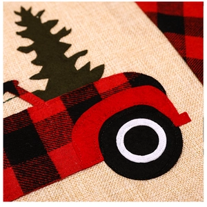 Close-up of burlap Christmas chair cover featuring truck applique and precise stitching