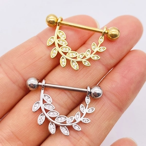 Surgical steel nipple rings with gold and silver leaf designs and sparkling zircon stones